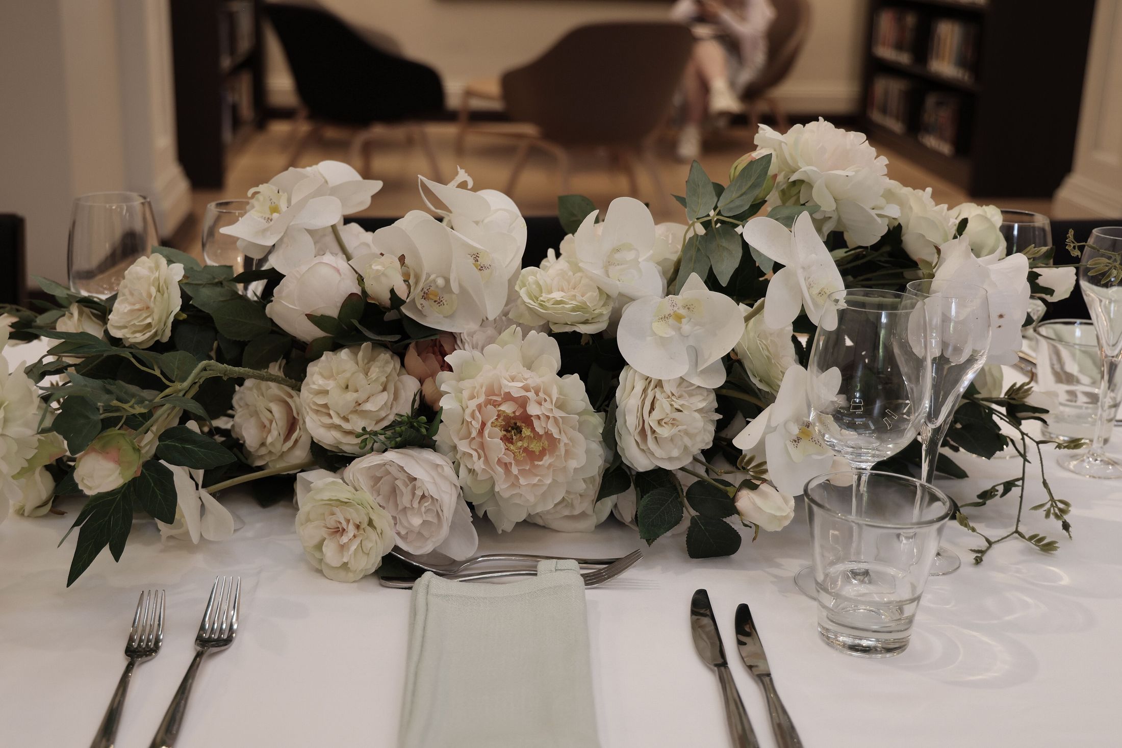 A wedding table laid with white flowers