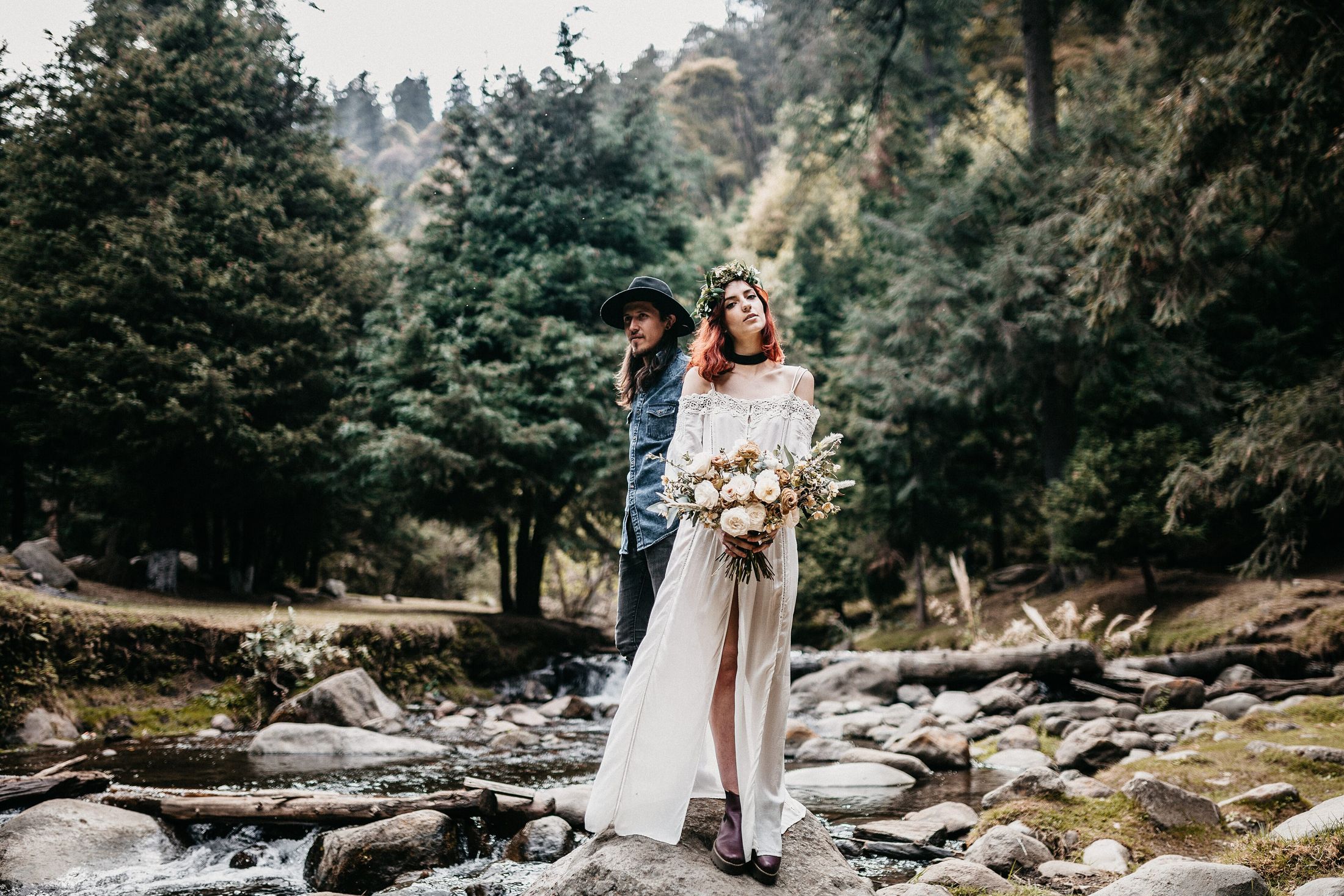 A couple by a woodland stream